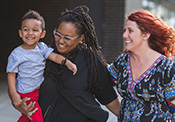 same sex female couple carrying a child